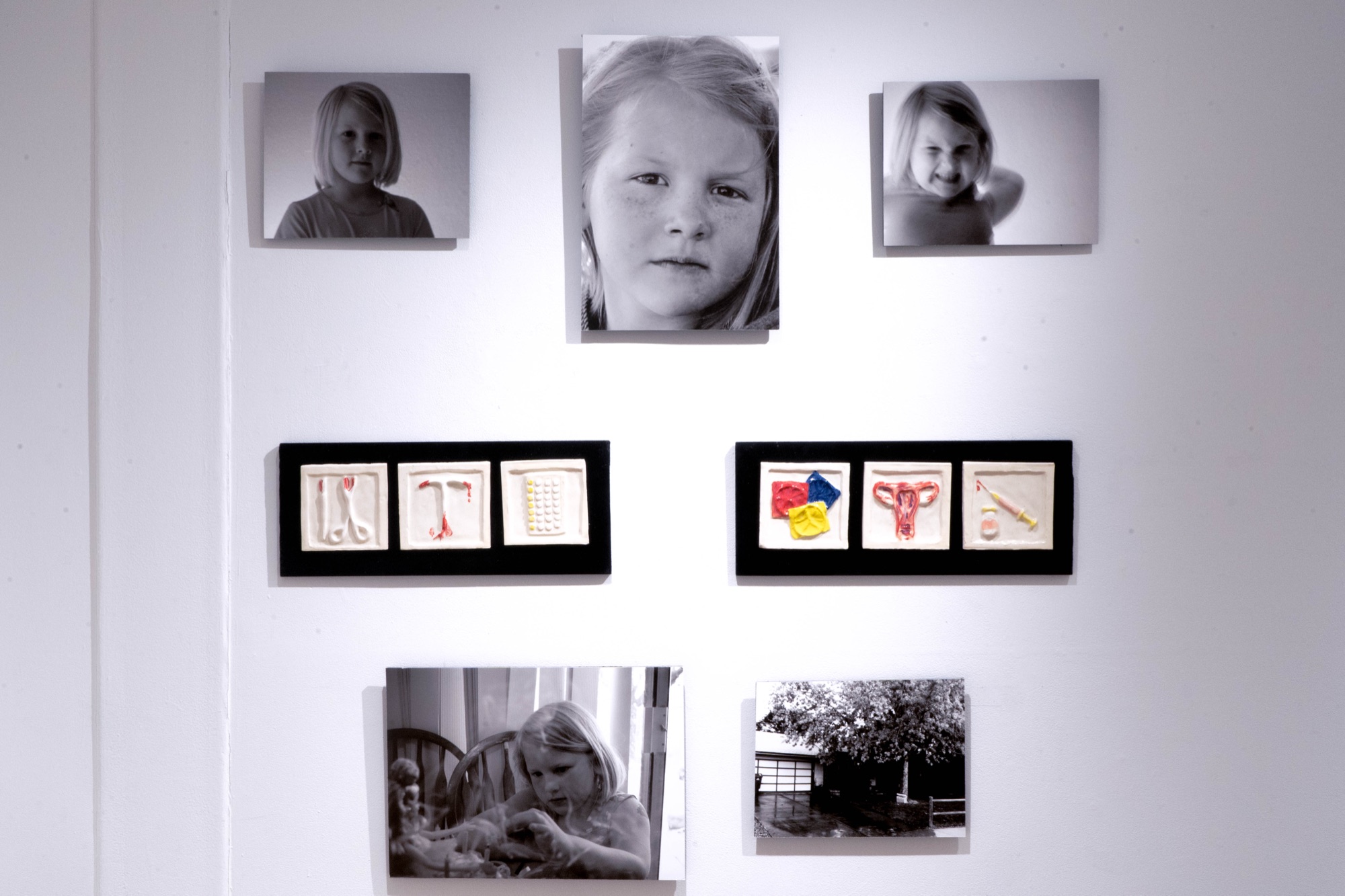 Framed portraits on a gallery wall